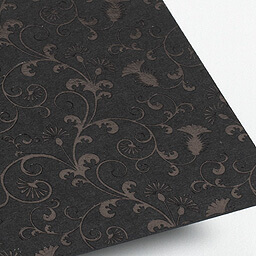 Black foil embossed onto uncoated black artboard. 